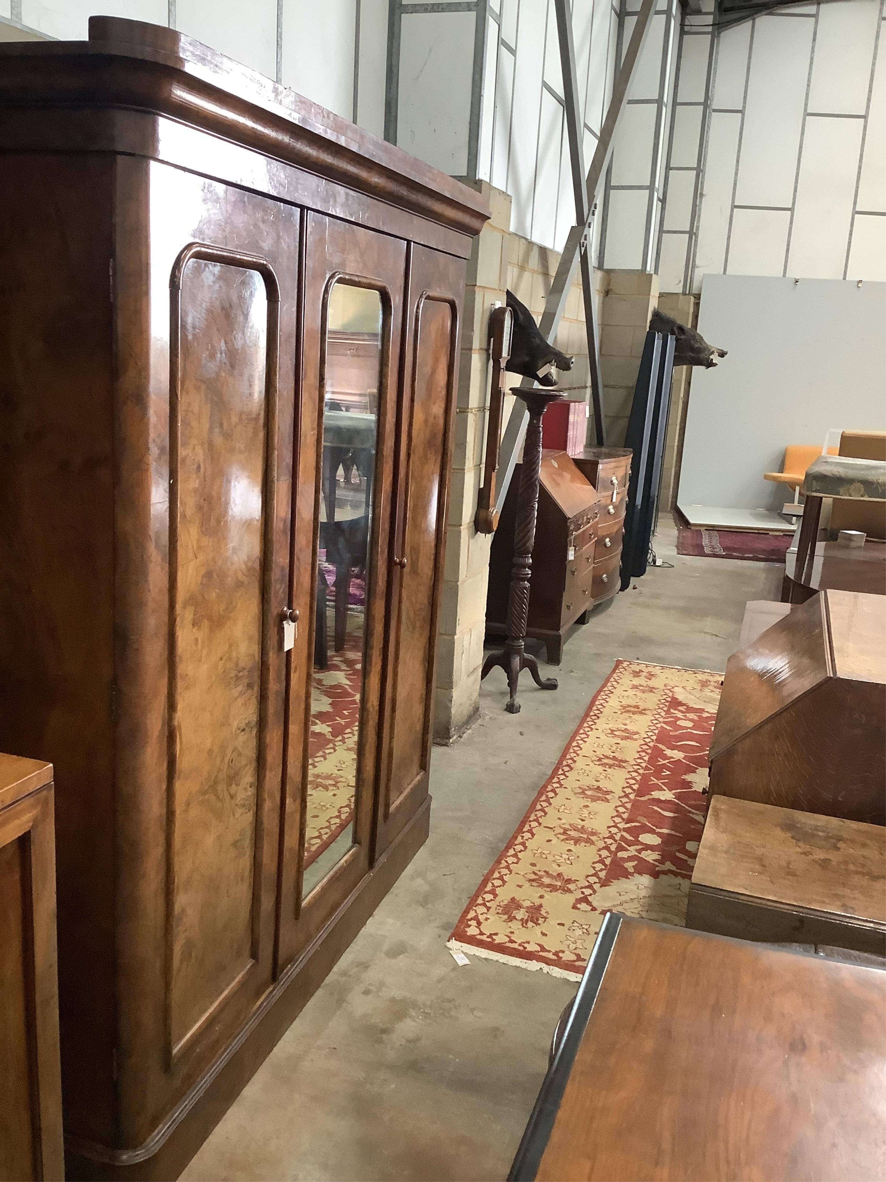 A Victorian figured walnut mirrored compactum wardrobe, width 192cm, depth 49cm, height 208cm. Condition - fair